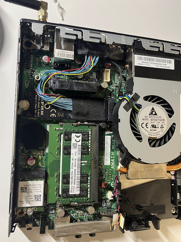Opened Lenovo ThinkCentre showing the internal OCuLink wiring and adapter installation